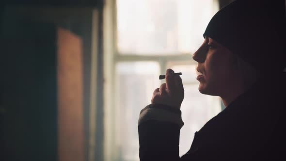 Addict Young Woman with a Cigarette