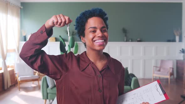 Young Happy African American Woman Shows Keys to Apartment or House