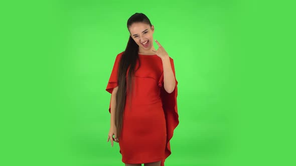 Pretty Young Woman Is Making a Rock Gesture and Enjoying Life. Green Screen