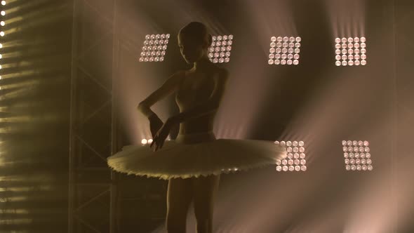 Diligent Young Graceful Ballerina Dancing Elements of Classical Ballet in the Dark with Light and