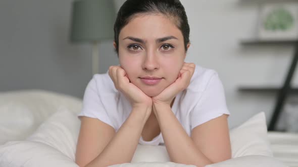 Indian Woman Looking at Camera in Bed