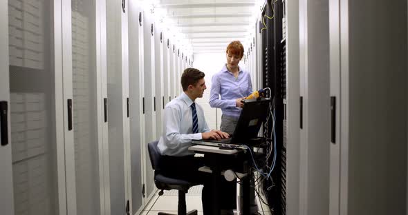Technicians Using Digital Cable Analyzer on Server