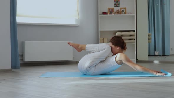 Young Woman Practicing Yoga in Studio