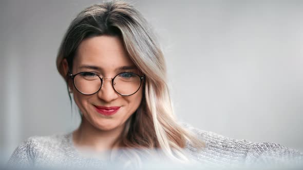 Face of Laughing Woman Watching Virtual Entertainment or Chatting Use Laptop