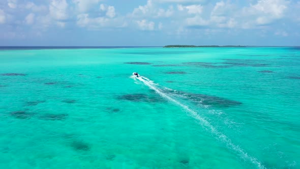 Aerial flying over nature of tranquil resort beach time by blue lagoon with white sandy background o