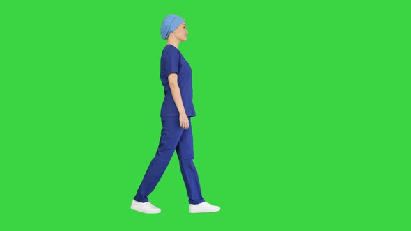 Confident Nurse or Doctor in Blue Uniform Walking Towards the Camera on a Green Screen, Chroma Key.