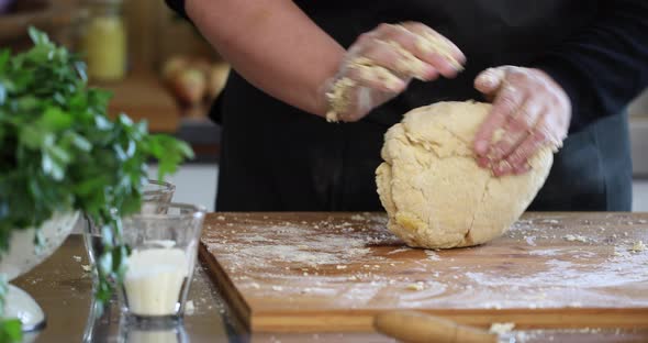 Woman kneading pasta dough for home made Maultaschen