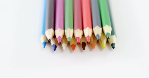 Close-up of colored pencils arranged in a row