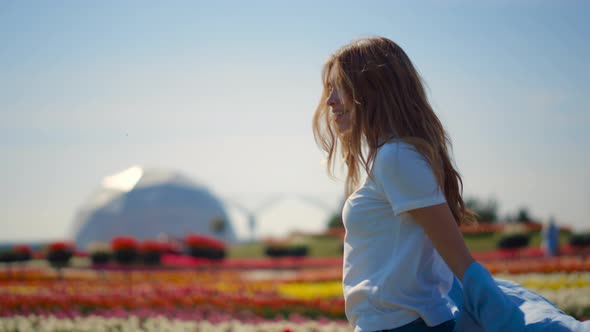 Beautiful Girl Dancing in Flower Garden