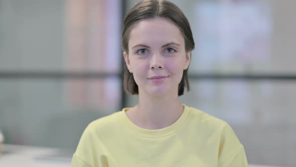 Portrait of Serious Young Woman Looking at the Camera