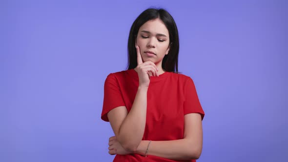 Thinking Woman Looking Up on Violet Studio Background