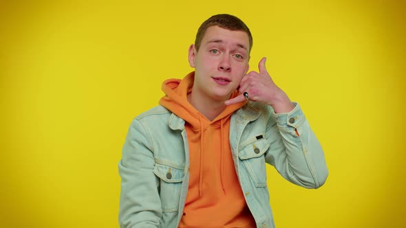 Teenager Man in Denim Jacket Looking at Camera Doing Phone Gesture Like Says Hey you Call Me Back