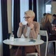 Portrait of Young Gorgeous Female Drinking Tea and Thoughtfully Looking Out of the Coffee Shop - VideoHive Item for Sale