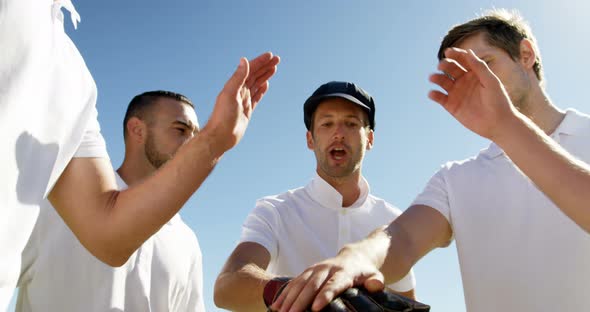 Cricket players forming a hand stack during cricket match