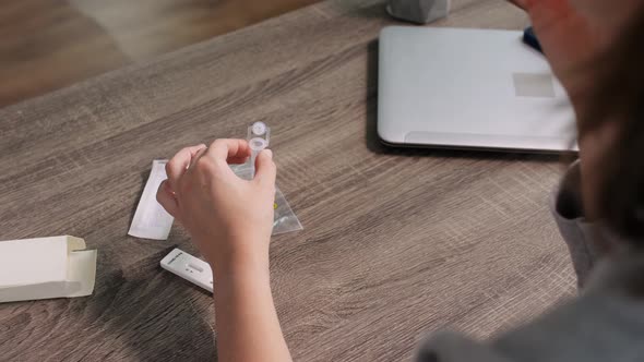 Woman Making Self Testing Coronavirus Test at Home