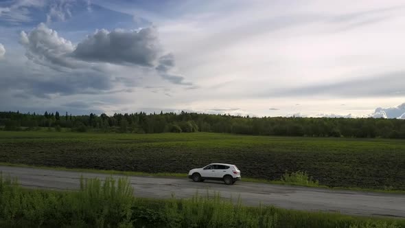 Sport Utility Vehicle Shakes Driving Along Grey Old Road