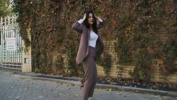 Beautiful Brunette Businesswoman In Business Clothes Walks In The City