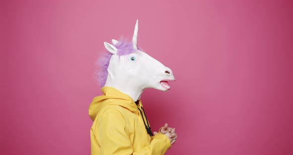 Male in Yellow Clothes with Unicorn Mask Shocked
