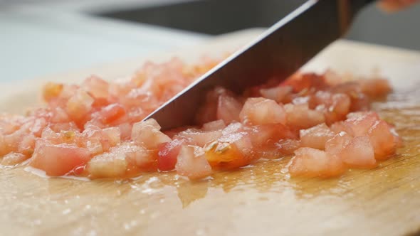 Cutting tomatoes on smaller pieces and arranging  with knife close-up 4K 2160p UltraHD footage - Fre