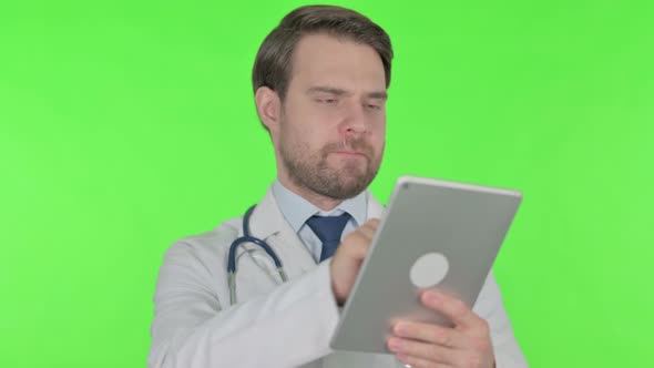 Young Doctor using Digital Tablet on Green Background