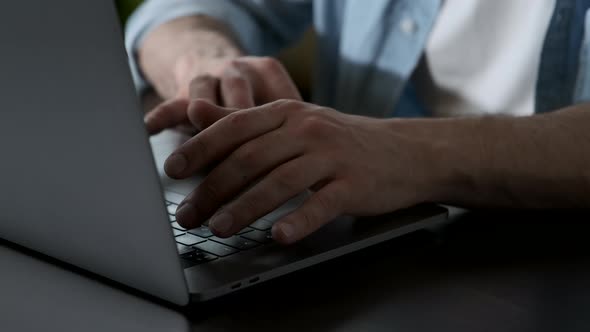 Close-Up of a Man's Hand Typing on a Computer Keyboard, Remote Online Mode in a Dark Room