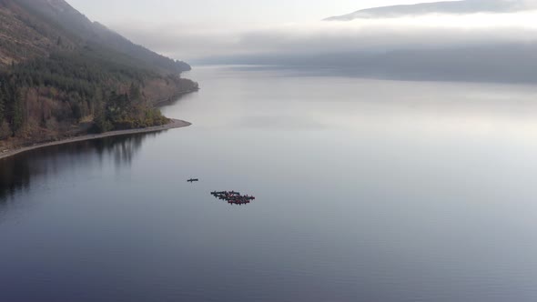 A Team of Canoeists on a Lake in the Early Morning