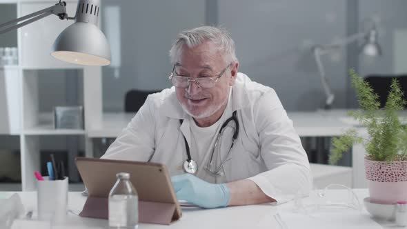 A Reliable Male Doctor Leads a Live Broadcast in His Video Blog on a Tablet