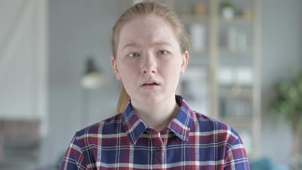 Close Up of Young Woman Shaking Head in Disapproval