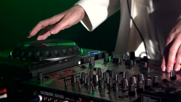 Dj Hands on Stylish Equipment Deck, Dancing and Playing, Close Up, Green Backlight