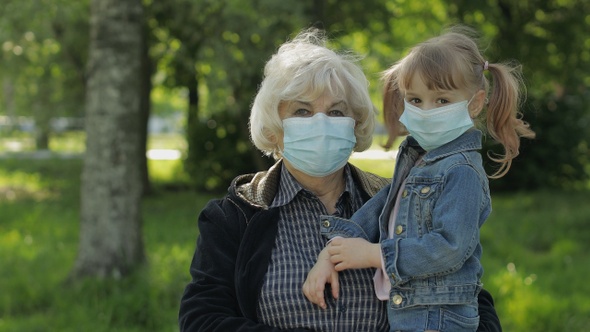 Grandmother with Granddaughter Takes Off Masks After Coronavirus Quarantine End