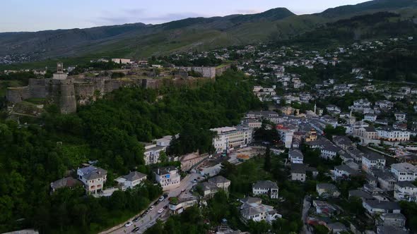 Aerial view of old city center of ancient forts, castles, houses and mountains in Gjirokaster, Alban