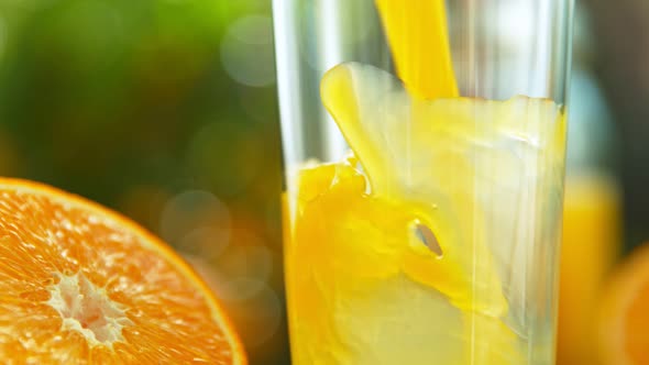 Super Slow Motion Shot of Fresh Orange Juice Being Poured in a Glass at 1000Fps