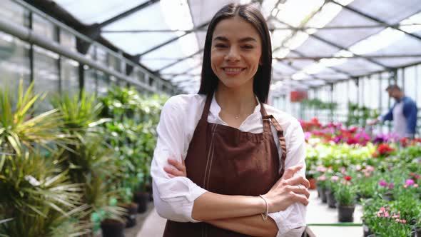 Smiling florist brunette woman looking at the camera