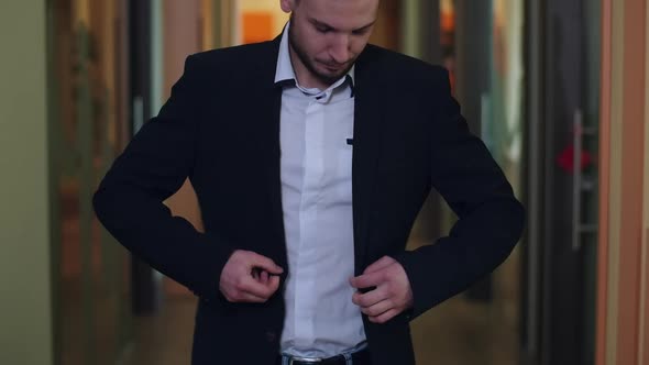 Unrecognizable Caucasian Office Worker Adjusting Suit As Standing in Corridor