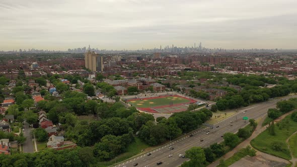 A bird's eye view over a parkway on a cloudy day. The drone trucks left and pan right slowly as the