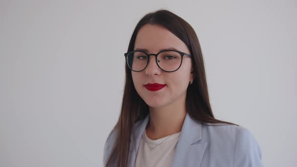 Portrait of a Confident Business Woman with Glasses on a White Background