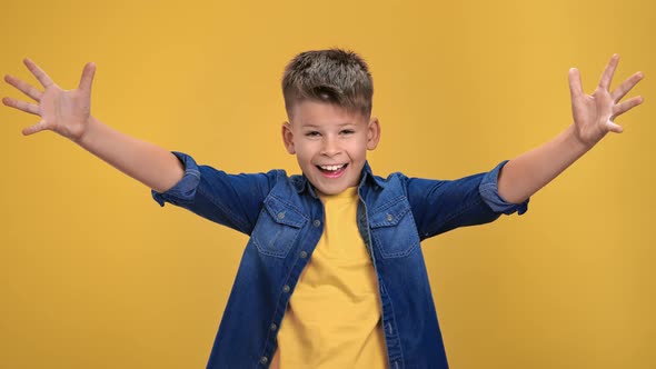 Portrait of Overjoyed Hospitality Boy Kid Greeting Raised Hands and Positive Emotion Posing Isolated