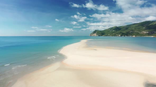 Fine White Sands Contrast with the Deep Greens of the Hills