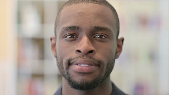 Close Up of Serious Young African Man Looking at the Camera