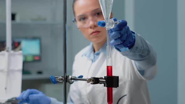Close Up of Scientist Using Laboratory Glassware on Desk