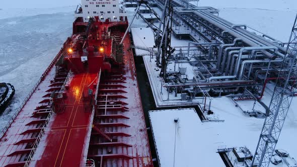 Oil Terminal and Tanker Moored on Water Covered with Ice