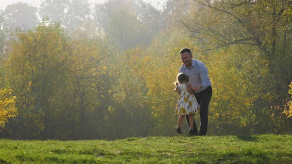 Father spinning his daughter