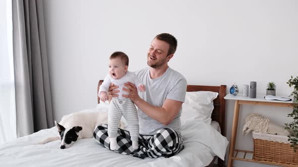 Father with Child and Dog in the Bed