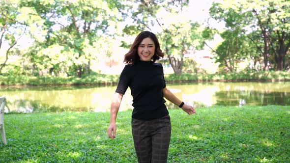 slow-motion of cheerful woman in the park