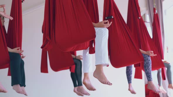 Relaxed Women Legs with Bare Feet Sitting in Hammocks