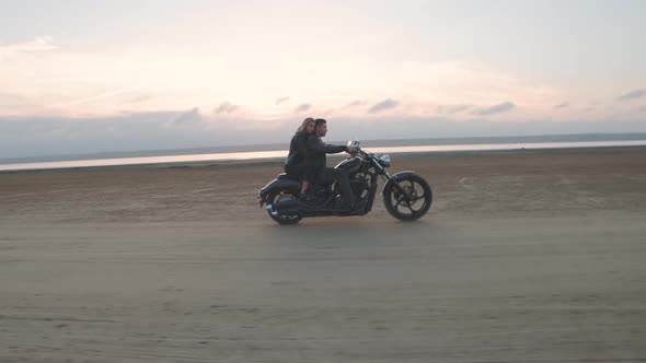 Guy with a Girl on a Motorcycle in the Desert