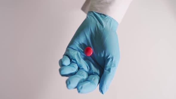 Female Doctor Offering Red Tablet, Unrecognizable Medical Professional Holding Medication