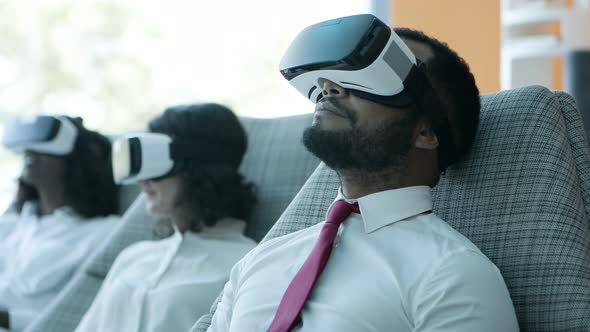 Business Colleagues Using Virtual Reality Headsets