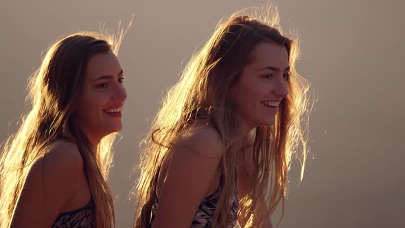 Twin teenagers talking and laughing with each other