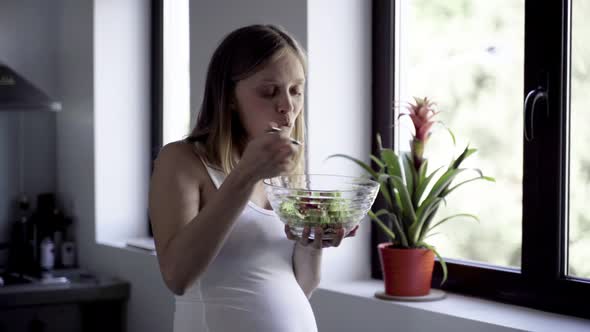 Cheerful Pregnant Woman Eating Fresh Salad